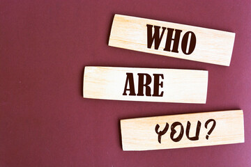 Who are you? question written wooden blocks.