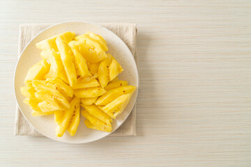 fresh pineapple sliced on plate