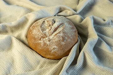 Appetizing freshly baked bread has just been put on the table.
