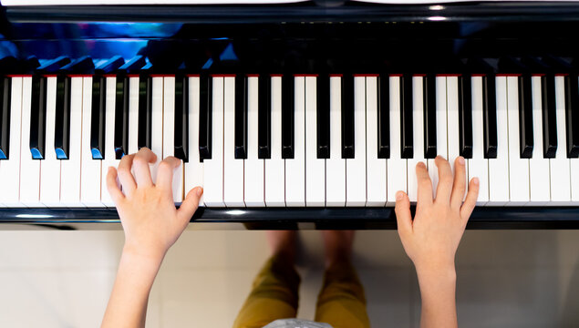 Playing piano top view, boy hand playing or practice piano top view