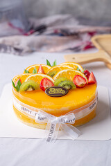 Fresh orange cake soft fudge decorated with orange kiwi fruit and strawberry for birthday cake.