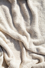 grey towel texture with deep shadow. soft cotton towel backdrop, fabric background. Terry cloth bath or beach towels. Soft fluffy Textile