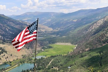 american flag in the mountains