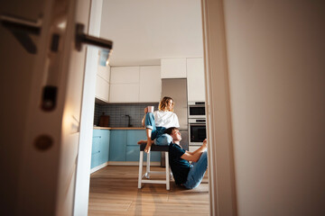 Fototapeta na wymiar Couple in love spending morning time on bright kitchen