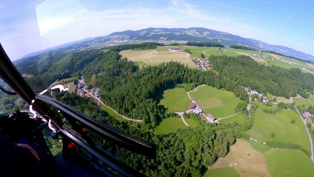 wide shoot from a helicopter where we are shown the green mountains of Austria splendid and wings of Blue and green colors of the forrest