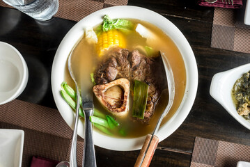 Top view of Beef Bulalo, a popular a beef soup dish from the Philippines. Served at a Filipino...