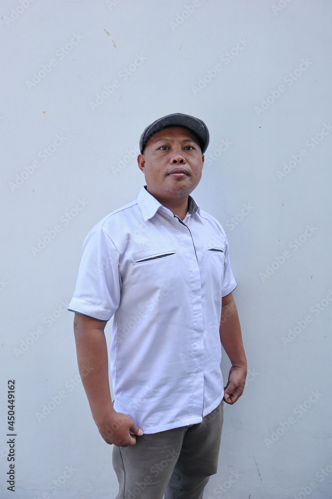 Wall mural grown man wearing a white shirt and wearing a hat                   