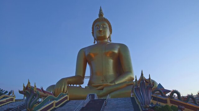 .The largest Buddha statue in the world at wat Muang Ang Thong Thailand. .landmark of Buddhism in Thailand at twilight..video 4K Nature video High quality footage for worship and travel concept..