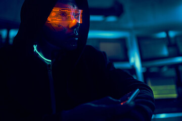 Cyber hacker breaks into databases to obtain information using a computer.