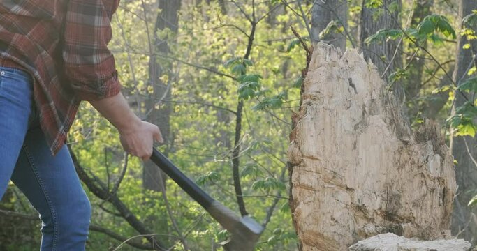 Powerful sideways axe swing at a tree stump