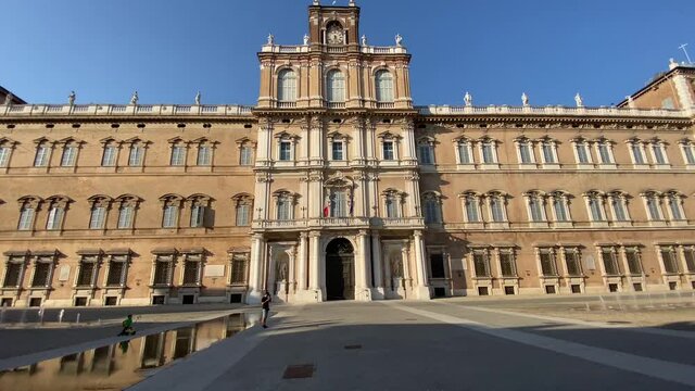 Modena, Italy - 11.08.2021; Piazza Roma. Facade ot military academy of Modena in a hot and sunny summer with very few people in the square. 