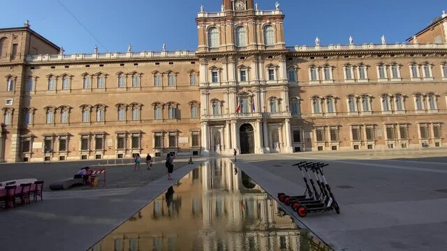 Modena, Italy - 11.08.2021; Piazza Roma. Facade ot military academy of Modena in a hot and sunny summer with very few people in the square. 
