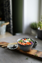 Bowl with rice, shrimp, salted salmon, edamame beans, red cabbage and fresh cucumbers. Healthy food in Asian style.