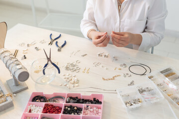 Professional jewelry designer making handmade jewelry in studio workshop close up. Fashion,...