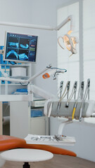 Interior of modern equipment oral office with teeth x ray on monitors, stomatology dentistry orthodontist medical clinic . Zoom in shoot. Hospital cabinet for dental health, care treatment