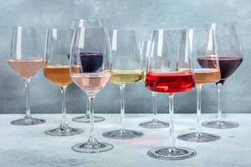 Variety of wine colors. Red, rose, and white wine in elegant glasses at a tasting at a winery