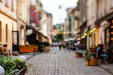 Fototapeta premium Unfocused cafes, buildings and people