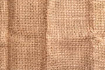 Texture of old crumpled sackcloth burlap with a folds