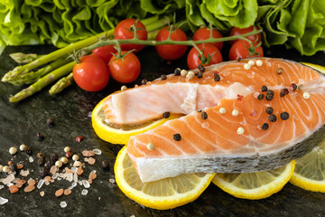 Raw salmon steak on a black board preparing for cooking