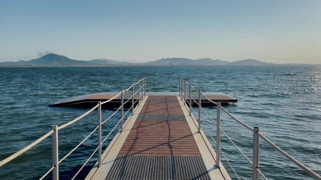 La Manga del Mar Menor in Murcia Spain Mediterranean Sea beach calm waters pier that juts into the sea at sunset