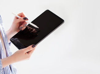 Woman holding iPad pro with white screen on white background. Office background
