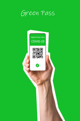 The digital green pass of the EU with the QR code on the screen of a mobile held by a hand with ...