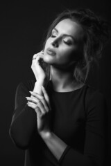 Monochrome studio portrait of a pretty woman with closed eyes