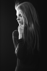 Black and white portrait of a stunning woman posing in the shadow