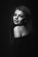 Black and white portrait of a flirty woman with bare shoulders