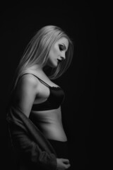 Sensual model wears bra and jacket posing at studio