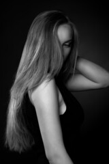 Adorable lady with long straight hair wears classic black dress