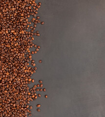 Fresh roasted coffee beans on dark background. Top view.