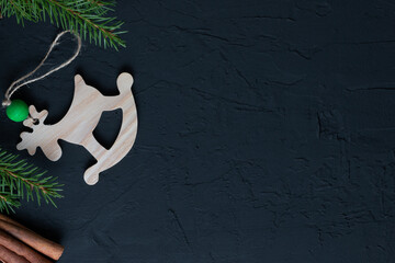 Banner Top view with Christmas toys and decorations on a dark background. Wooden toy deer for the Christmas tree. The concept of a New Year's holiday. Space for text. flat lay