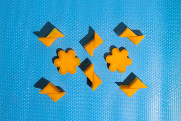 Geometric shapes made of sliced melon lay down on a pastel blue background. Summer refreshment concept, flat lay composition