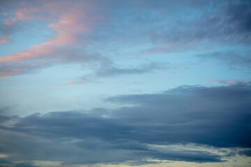 Naklejka na ściany i meble Rain clouds in the sky at sunset