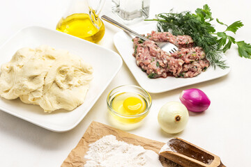 Raw dough on plate. Flour on paper.