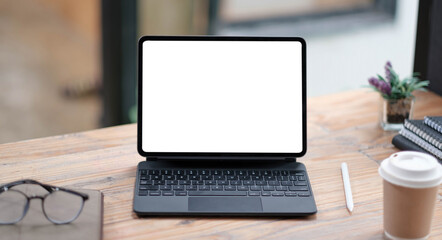 Close-up view of open blank screen laptop computer with office supplies in modern office