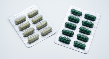 Two different blister pack of Andrographis paniculata capsules on white background. Take Andrographis paniculata when having a fever, cough, and sore throat.