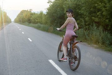 Fototapeta premium The girl cyclist is engaged in sports, the concept of a healthy lifestyle