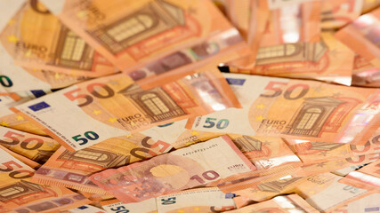 Texture of 50 euros, many identical bills that lie together.