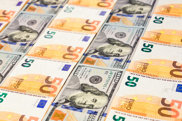 Dollars and euros, confrontation and domination, influence, world currencies close up.