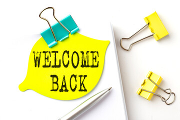 Sticker with WELCOME BACK text on notebooks on the white background