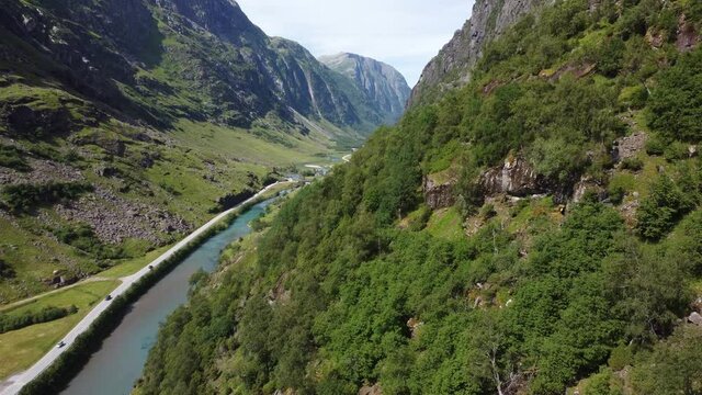 Tourists are traveling through mountain valley to reach northern Norway - Stardalen E-39 Norway aerial - View up from mountainside