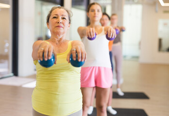 Fototapeta na wymiar Aerobics pilates women with toning balls in a row on fitness class