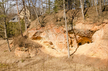 Fototapeta na wymiar Beautiful sandstone cliffs with caves in Latvia.