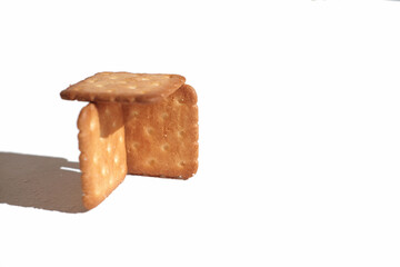 crispy salted crackers on white background. selective focus, direct light. high fat and carbs food