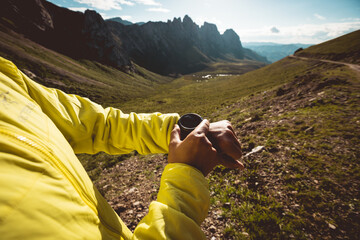 Woman on high altitude mountain top checking the altimeter on the sports watch