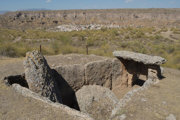 Megalithic dolmen with Gorafe town at background, megalithic park, Spain