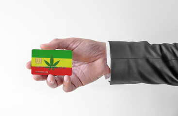 Bank credit plastic card with flag of Rassta holding man in elegant suit