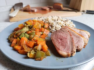 Duck breast with rice and vegetables carrot broccoli onion